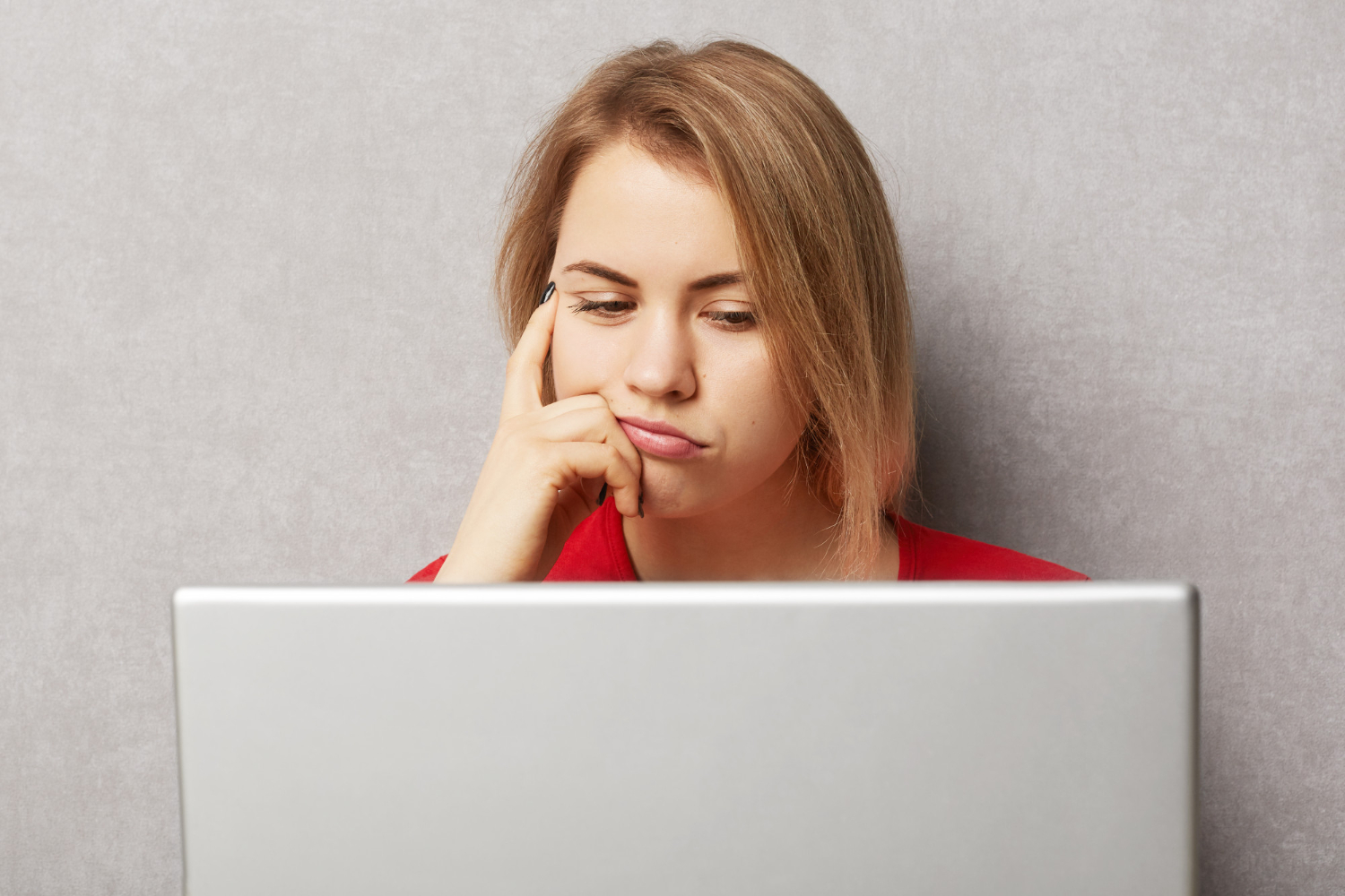 Woman thinking at five key web accessibility principles, including keyboard navigation, screen readers, color contrast, alt text for images, and video captions.